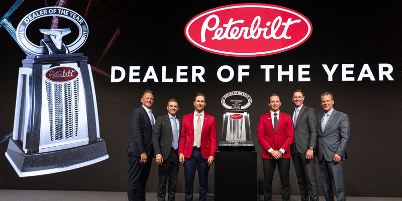 Greg and Jeff Arscott accepting Peterbilt's 2024 Dealer of the Year award