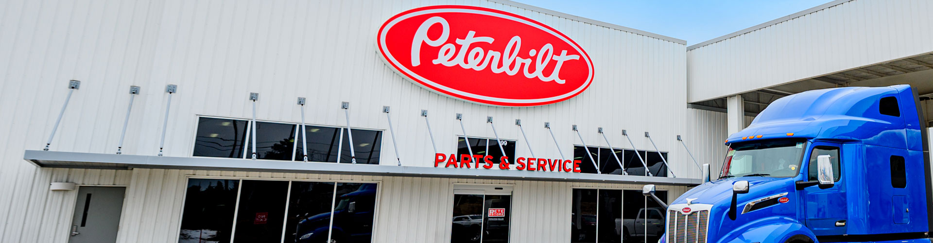 Front of The Pete Store building, a Peterbilt/Semi-Truck Dealership, showing off our Parts and Service Department