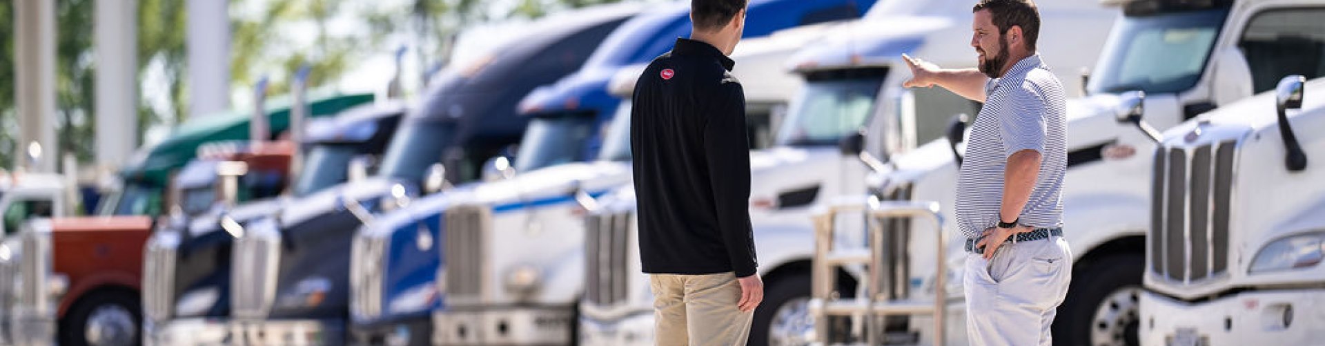 semi-trucks on a dealership lot ready to be sold